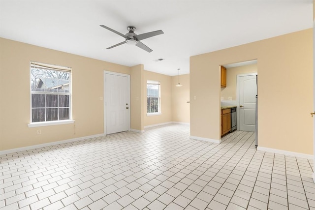 unfurnished living room featuring light tile patterned flooring, a healthy amount of sunlight, and ceiling fan