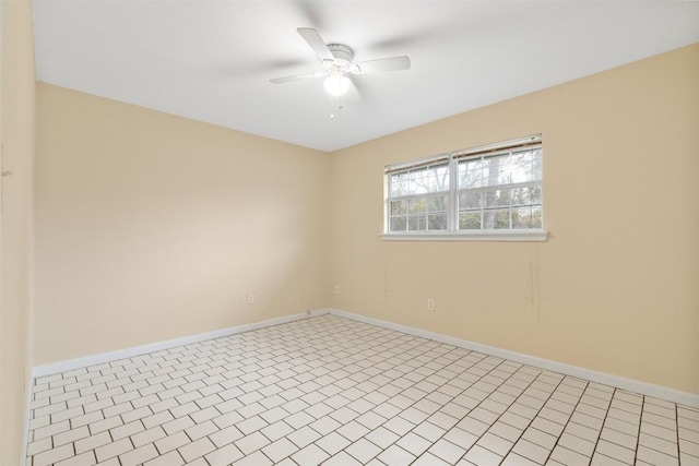 tiled spare room featuring ceiling fan