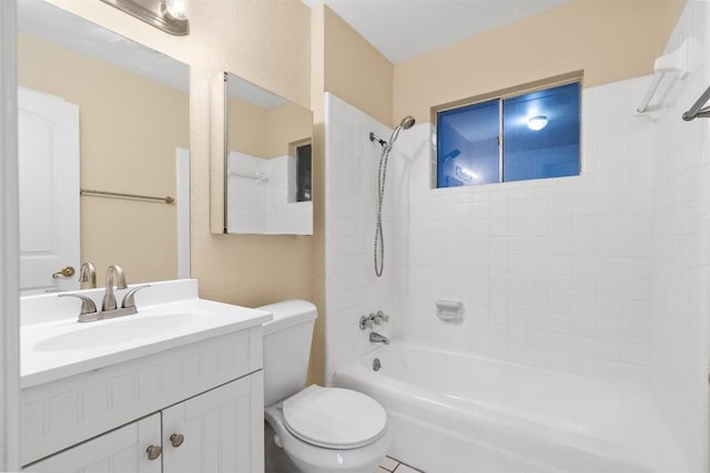 full bathroom with tiled shower / bath, vanity, and toilet