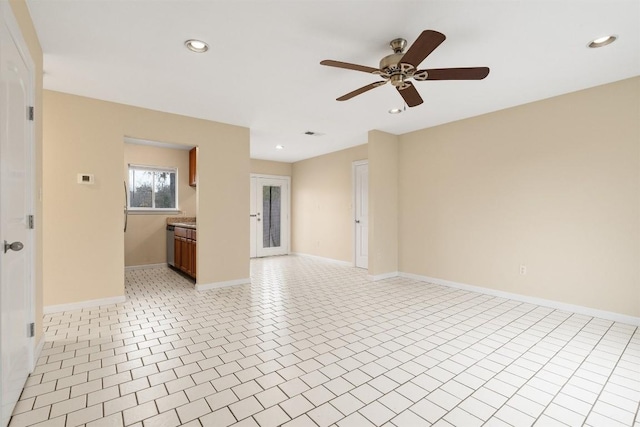 unfurnished living room featuring light tile patterned flooring and ceiling fan