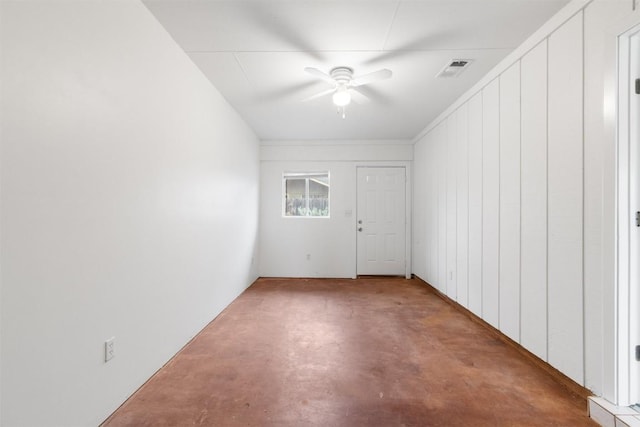 spare room with concrete floors and ceiling fan