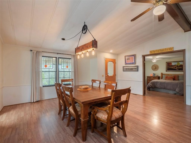 dining space featuring light hardwood / wood-style flooring, lofted ceiling with beams, and ceiling fan