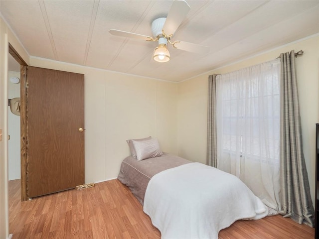 bedroom featuring light hardwood / wood-style flooring and ceiling fan