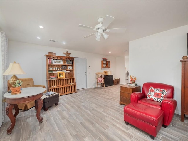 sitting room featuring ceiling fan and light wood-type flooring