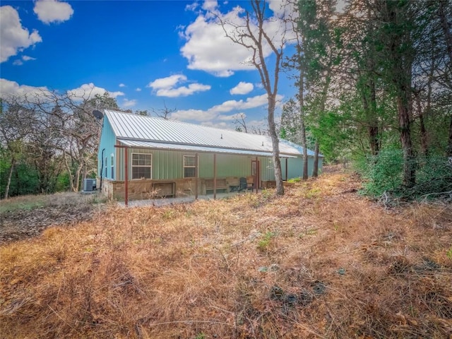 rear view of property with cooling unit