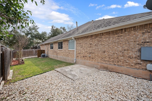 exterior space with central AC, a patio area, and a lawn