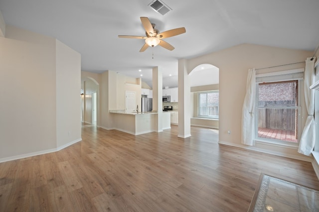 unfurnished living room featuring ceiling fan, lofted ceiling, and light hardwood / wood-style floors