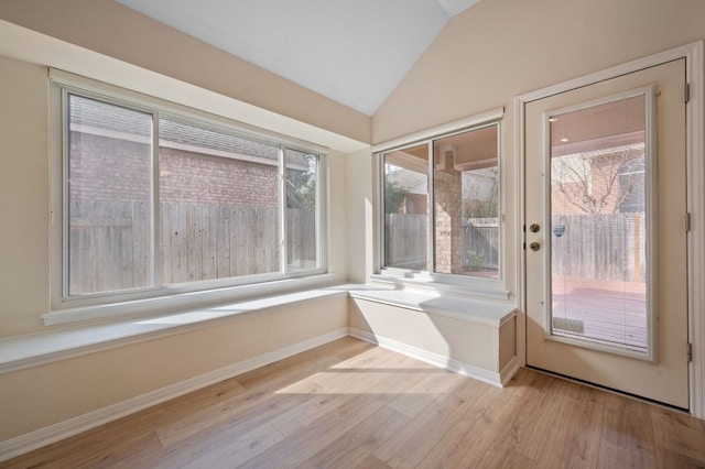 unfurnished sunroom with lofted ceiling