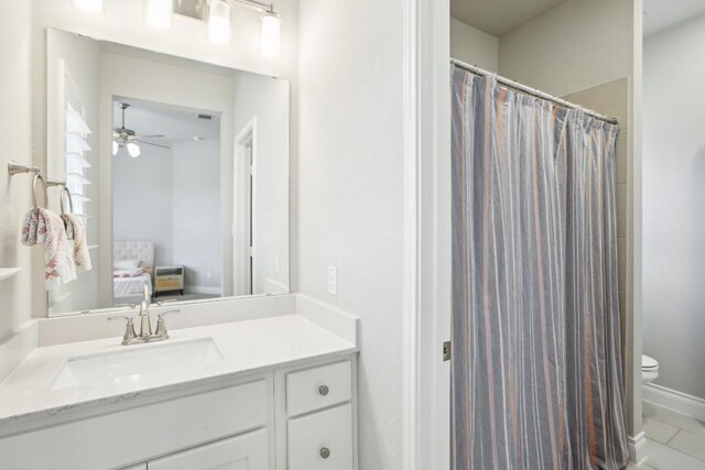 bathroom featuring vanity, ceiling fan, and toilet