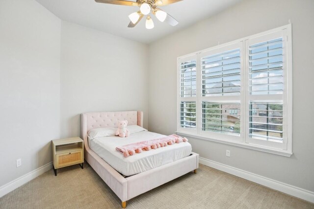 bedroom with ceiling fan and light carpet