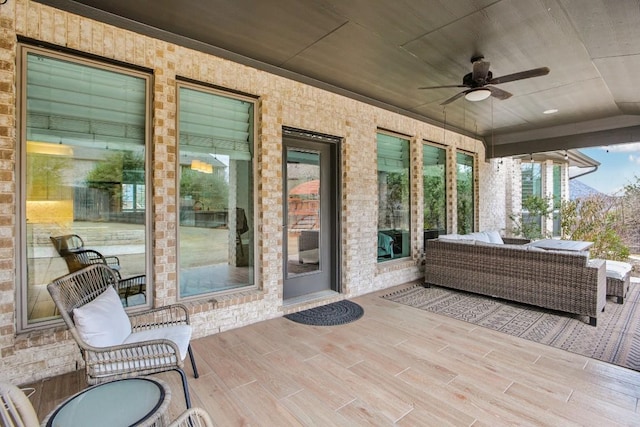 view of patio / terrace with ceiling fan and an outdoor living space