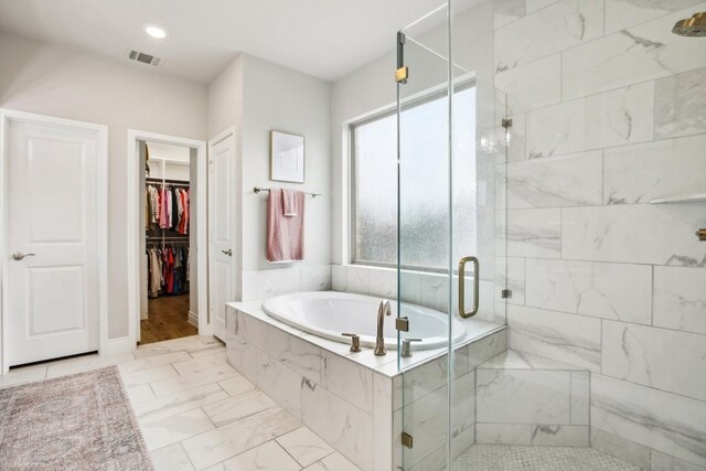 bathroom with shower with separate bathtub