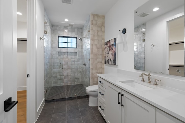 bathroom with vanity, an enclosed shower, and toilet