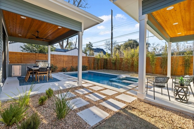 view of swimming pool featuring a patio, an in ground hot tub, and ceiling fan