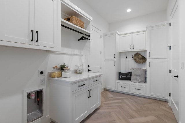 interior space featuring cabinets, light parquet floors, and hookup for an electric dryer