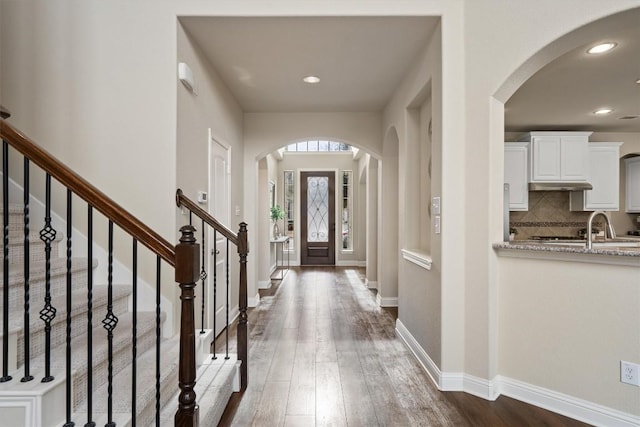 foyer entrance with dark wood-type flooring and sink