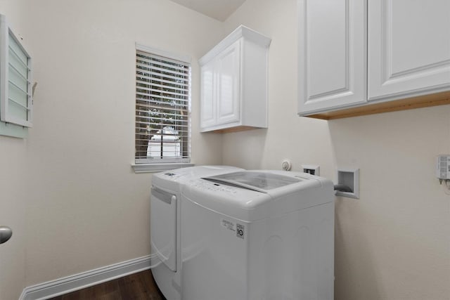 clothes washing area with cabinets, dark hardwood / wood-style floors, and independent washer and dryer