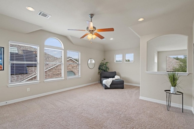 unfurnished room with light colored carpet and ceiling fan