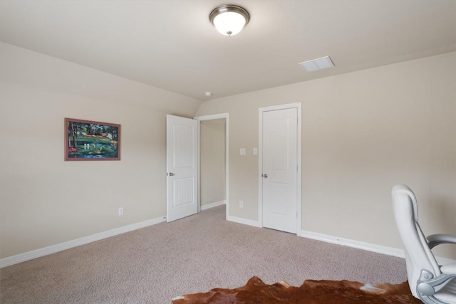 unfurnished office with light colored carpet and lofted ceiling