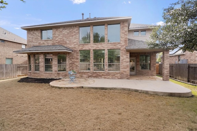 back of property featuring a yard and a patio