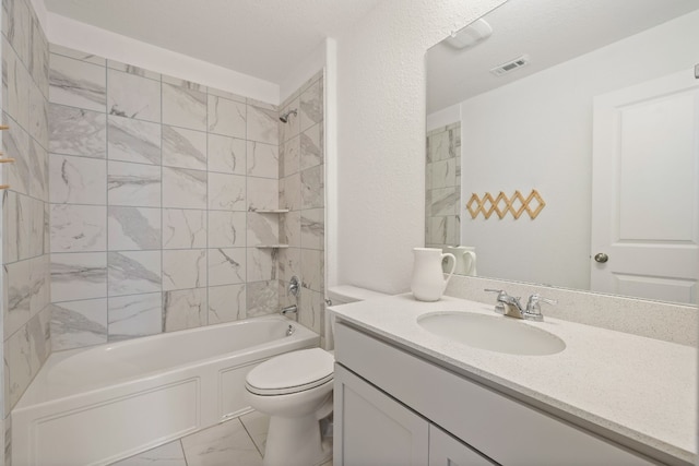 full bathroom with vanity, tiled shower / bath combo, a textured ceiling, and toilet