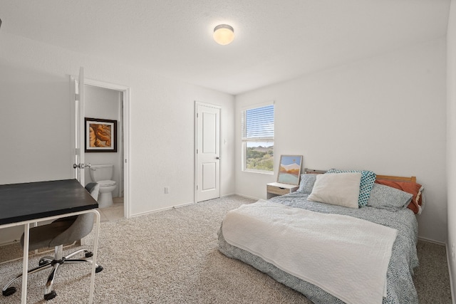 carpeted bedroom with ensuite bathroom