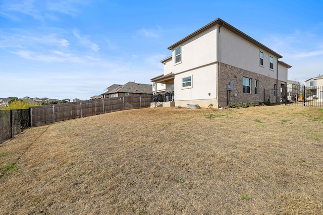 rear view of house with a yard