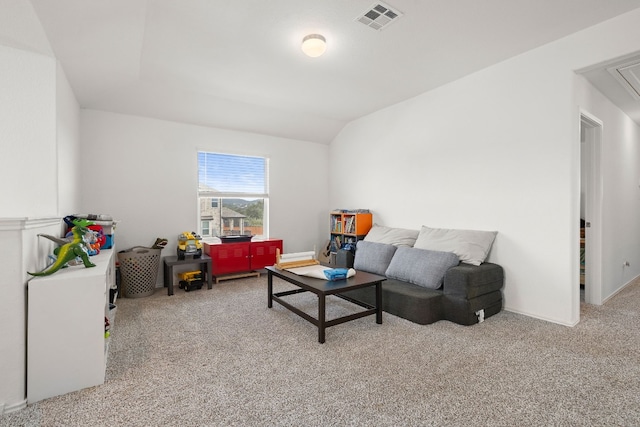 carpeted living room with vaulted ceiling