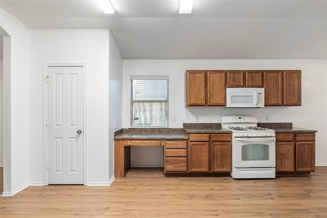 kitchen featuring white appliances and light hardwood / wood-style flooring