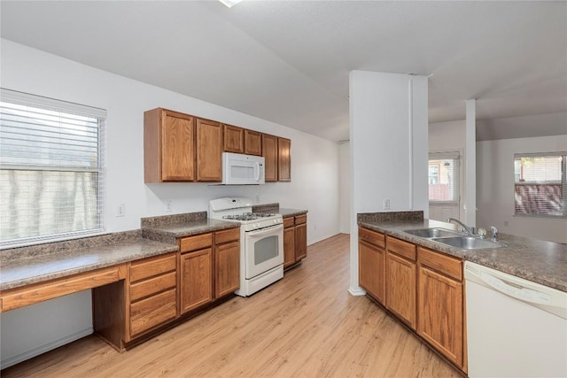 kitchen with white appliances, sink, and light wood-type flooring