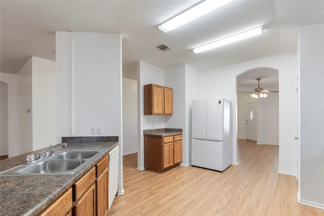 kitchen with ceiling fan, sink, white appliances, and light hardwood / wood-style floors