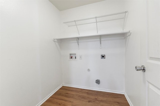 laundry area featuring gas dryer hookup, electric dryer hookup, washer hookup, and dark hardwood / wood-style flooring