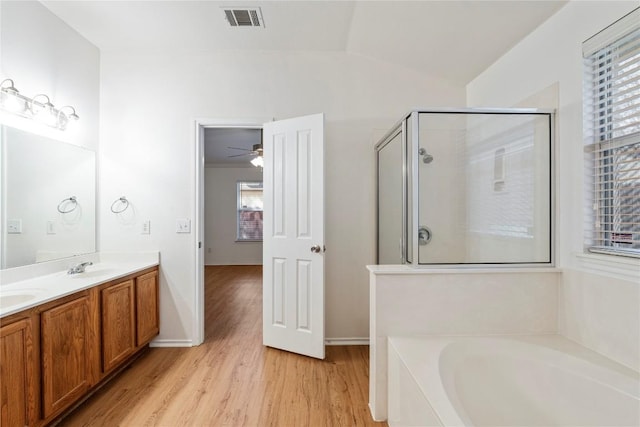 bathroom featuring hardwood / wood-style flooring, lofted ceiling, separate shower and tub, and vanity