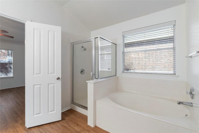 bathroom with hardwood / wood-style floors, plenty of natural light, shower with separate bathtub, and ceiling fan