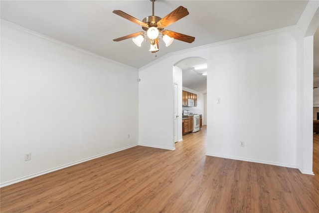 empty room with crown molding, light hardwood / wood-style floors, and ceiling fan