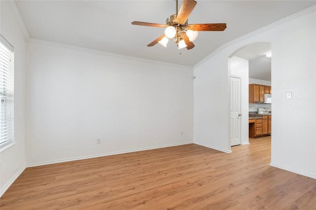 unfurnished room with crown molding, ceiling fan, and light hardwood / wood-style floors