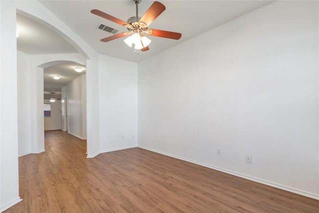 empty room with ceiling fan and light wood-type flooring