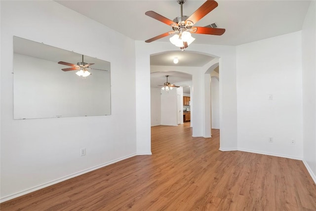 unfurnished room with ceiling fan and light hardwood / wood-style floors