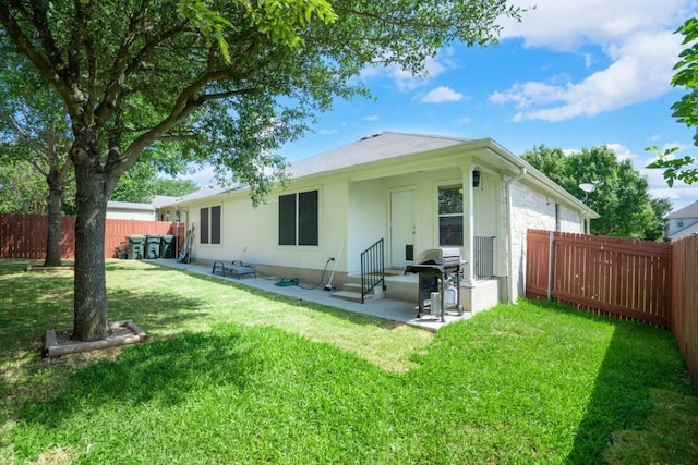 rear view of property with a patio area and a lawn