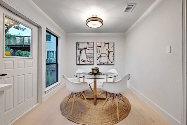 dining space with hardwood / wood-style flooring