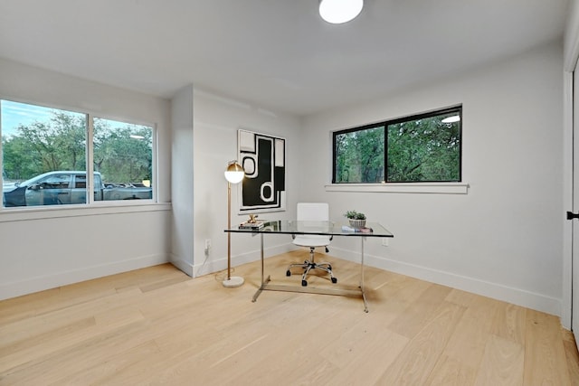 office with light hardwood / wood-style flooring