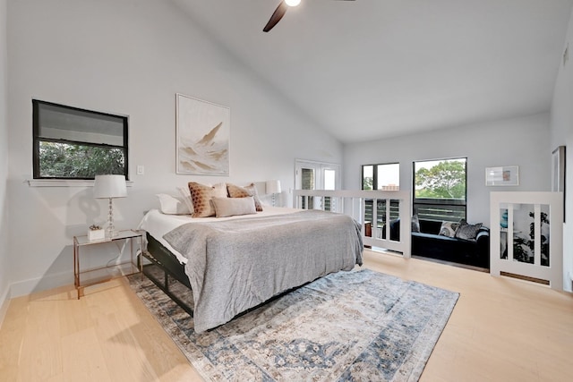 bedroom featuring ceiling fan, hardwood / wood-style floors, access to exterior, and high vaulted ceiling