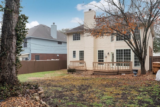 back of house featuring a deck