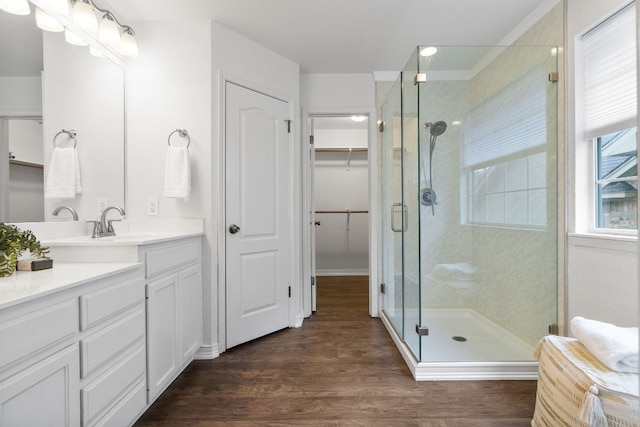 bathroom featuring vanity, hardwood / wood-style floors, and walk in shower