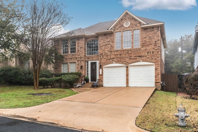 view of front of house with a garage and a front lawn