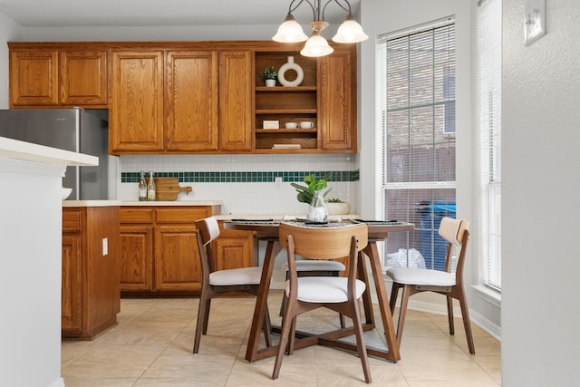 kitchen featuring a healthy amount of sunlight, hanging light fixtures, and backsplash