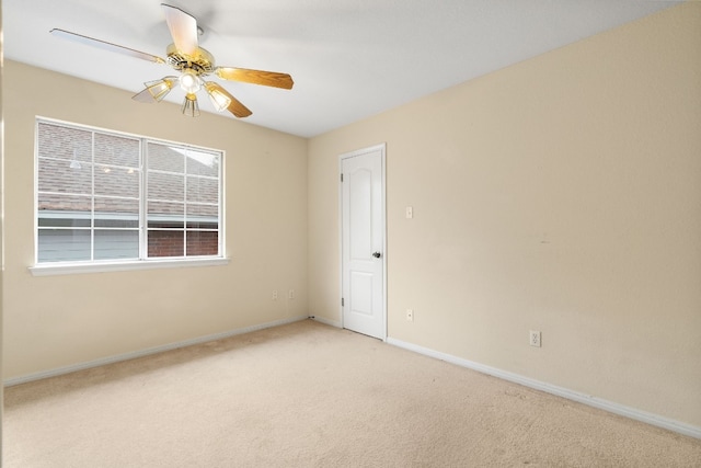 carpeted spare room with ceiling fan