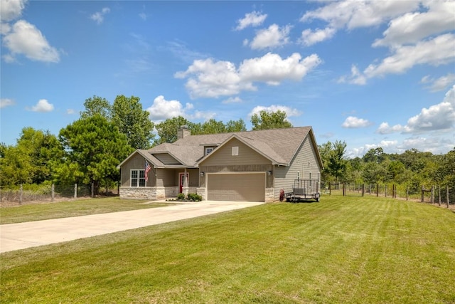 view of front of property with concrete driveway, stone siding, an attached garage, fence, and a front yard