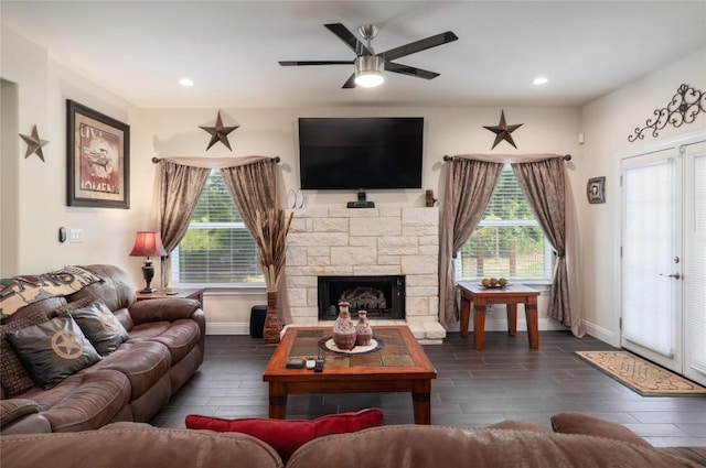 254 Cardinal Loop, Paige, TX 78659 - living room featuring a ceiling fan, baseboards, dark wood-type flooring, a fireplace, and recessed lighting