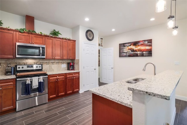 254 Cardinal Loop, Paige, TX 78659 - kitchen featuring stainless steel appliances, a sink, dark wood finished floors, decorative backsplash, and light stone countertops